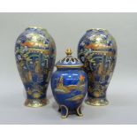 A pair of Carlton ware baluster vases printed in gilt and enamelled on a blue ground with a