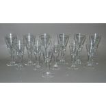 A set of six Dartington wine glasses with tear filled stems; together with a set of six matching