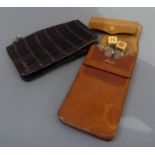 An English hide four cigar case, 15cm high; a faux crocodile purse and a set of dice in pigskin case