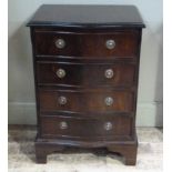 A reproduction serpentine fronted chest of four drawers on shaped bracket feet