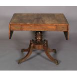 A Regency rosewood sofa table, having twin drop leaves, beaded flush frieze drawer and opposing