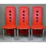 Three red highback chairs on chrome framing