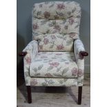 An button backed upholstered armchair on square tapered legs
