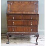 A reproduction mahogany bureau, fall front over three drawers cabriole legs