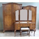 A four piece figured walnut bedroom suite comprising lady's and gent's wardrobe, dressing table with