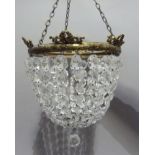 A circular bag shaped chandelier the corona ribbon tied with brass laurel frame and graduated