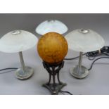 A set of three opaque white glass and chromium plated table lamps; together with another bronzed