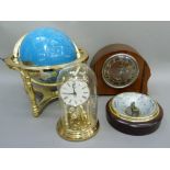 A terrestrial globe in gilt metal stand, a torsion clock under dome, a barometer, and a vintage