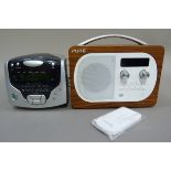 A Pure DAB radio in wood effect case with remote control, together with a Roberts dual alarm CD