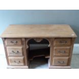 A pine desk having a shell carved apron flanked by three drawers to either side
