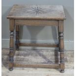 A late Victorian oak occasional table, the rectangular top carved with a foliate carved lozenge,