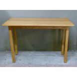 A pine rectangular table on square legs