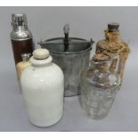 A vintage stoneware bottle, thermos flask, two wicker wrapped glass flasks, a glass jug with cork