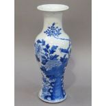 A 19th century Chinese blue and white vase of baluster outline painted with songbird amongst
