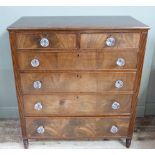 A Victorian figured mahogany chest of two short and four long graduated, cockbeaded drawers, flanked