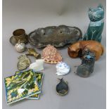 Decorative items including, carved wooden cats, pottery tiles, tin can cat sculpture, brass hand,