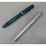 Two Parker ink pens with 14k gold nibs one in green plastic with gilt clip the other in a