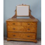 A late Victorian satin birch dressing table the rectangular plate on a pair of leaf carved uprights,