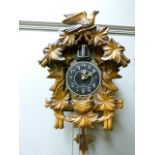 A reproduction resin cuckoo clock quartz movement, 40cm high; together with two other reproduction