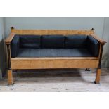 A Beidermeir style maple veneered and ebonised sofa of geometric outline on square legs with block