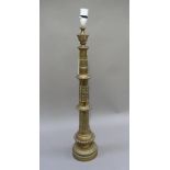 A Victorian brass table lamp, of Gothic design tapered cylindrical with beaded collars and trefoil