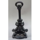 A cast iron foliate scroll door porter with post and ring handle, 40cm high