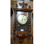 An early 20th century Vienna walnut wall clock with cream papered dial with Roman numerals,