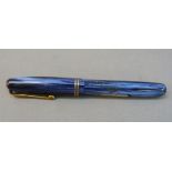 A Watermans 512V fountain in blue marbled case with gilt clip and filler and 14k gold nib