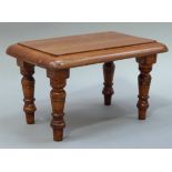 A reproduction pine small stool the rounded rectangular top above turned legs, 30cm wide