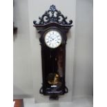 19th century Vienna wall clock with ebonised pierced shell and foliate scroll cresting, shaped