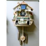 Two resin Flying Scotsman cuckoo style clocks, 34cm high approximately