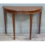 A George III style mahogany side table of bowed form on square tapered legs with spade feet, 98cm