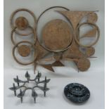 A metal candlestand, the back plate pierced in a design of circles, together with four Danish