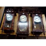 A Burroughs wall clock with mahogany stained case; a thirty-one day wall clock in mahogany stained