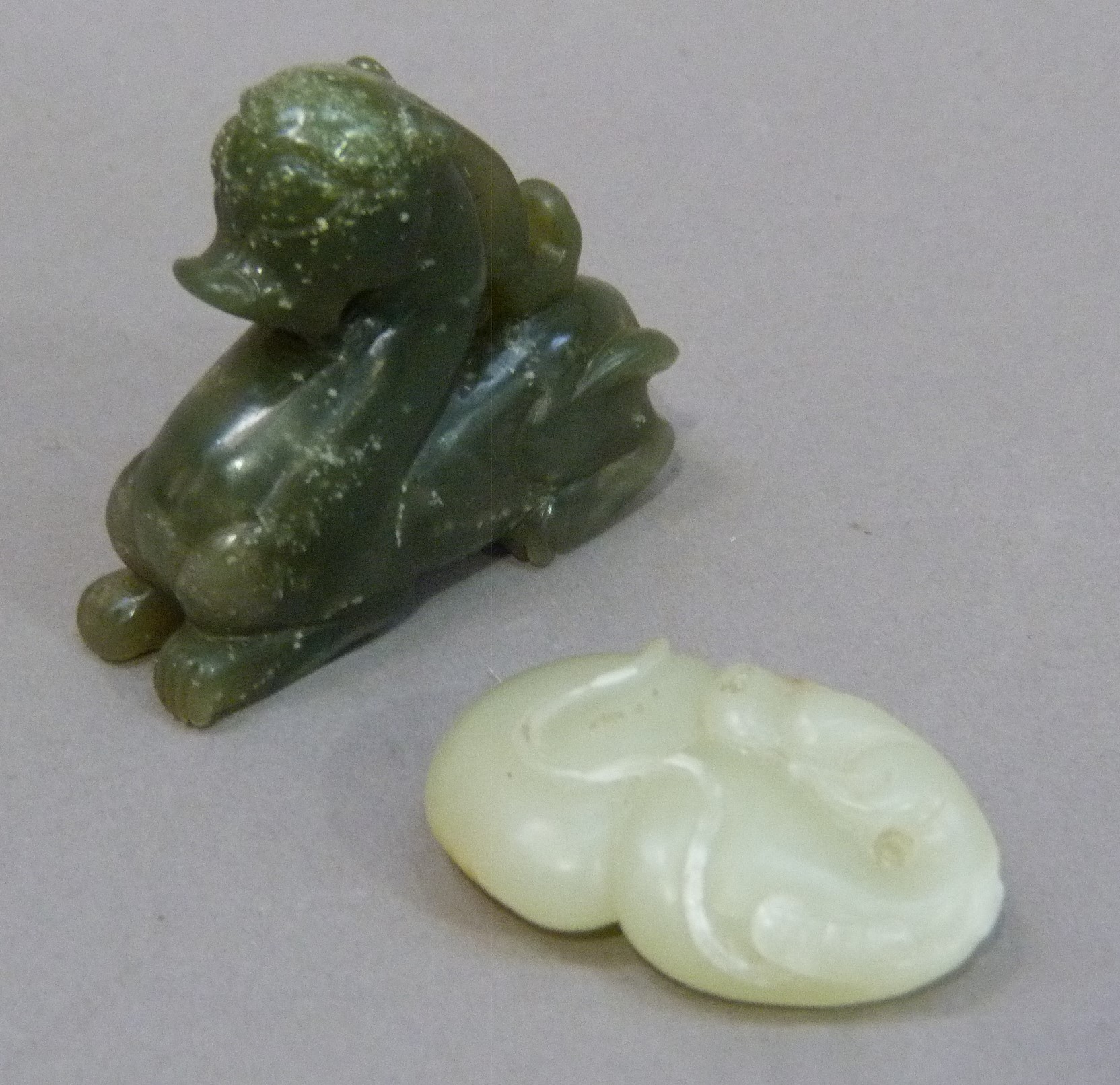 Two jadeite carvings of a dragon and an insect sitting upon a peach, dragon 6cm x 5.5cm, insect