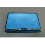 A sterling standard engine turned turquoise blue enamel card case of book form with hinged lid and
