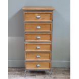 A reproduction pine chest of six drawers within a silver painted metal frame on pierced squat
