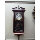 A highland wall clock in mahogany stained case with architectural pediment the circular dial with