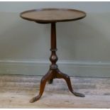 A mahogany tripod table having dished top, vase turned column and on three leaf carved cabriole legs