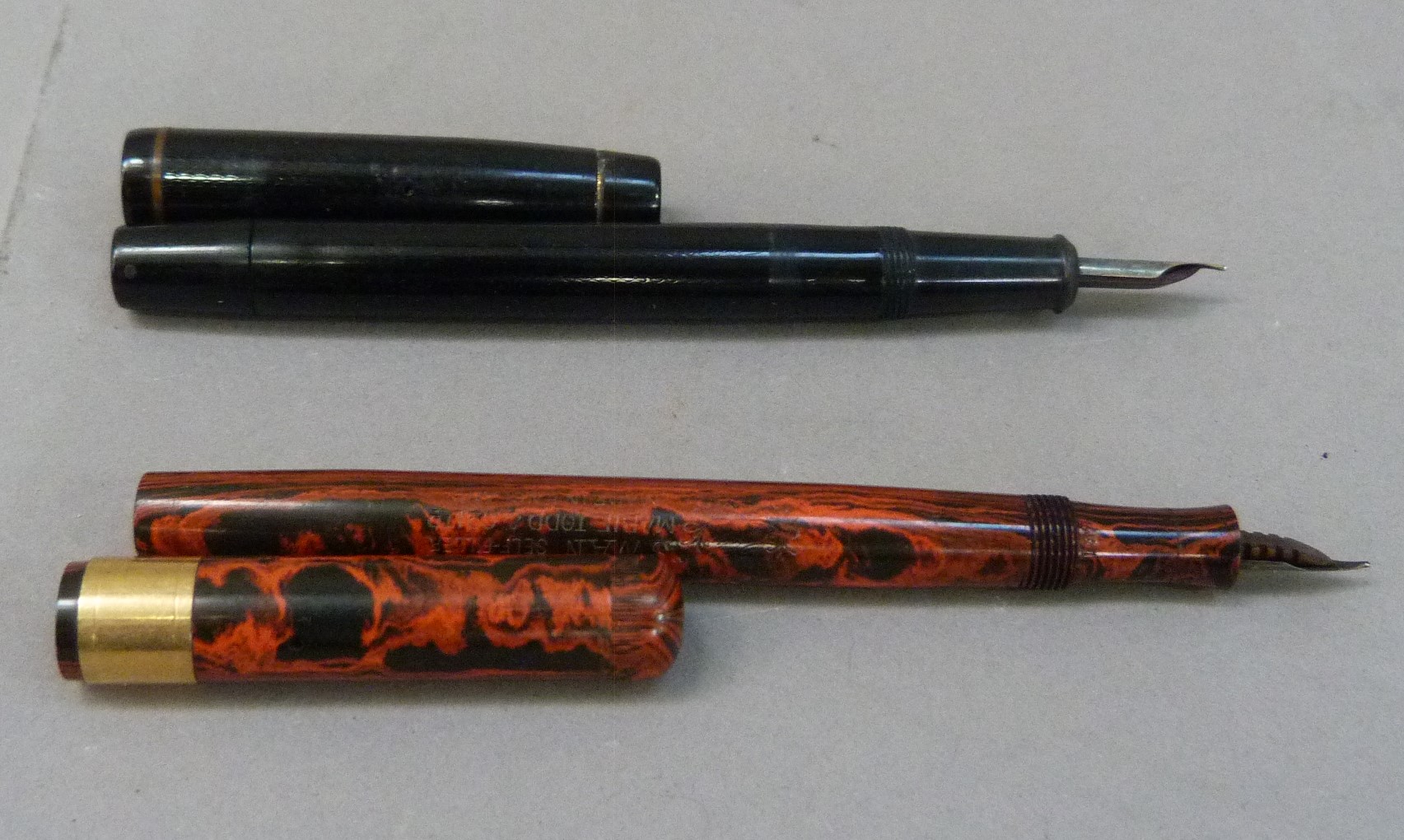 A De La Rue Onoto fountain pen in black plastic case with yellow metal clip and 14k gold nib;