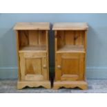 A pair of reproduction pine bedside cupboards the rectangular tops with moulded lips above an open