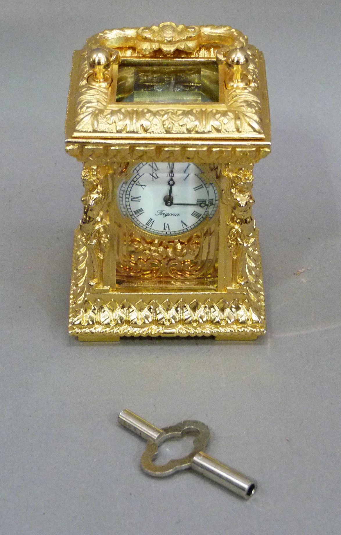 A reproduction gilt metal carriage clock in ornate Rococo case with foliate scroll carrying - Image 2 of 3