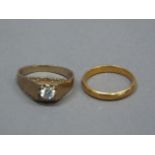 A wedding ring in 22ct gold, approximate weight 3gm, together with a 9ct gold ring set with a