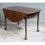 A 18th century mahogany Pembroke table having twin oval drop leaves on bowed aprons and on rounded