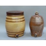 Two salt glazed barrels, one with later wooden top, 34cm high and smaller