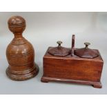 A turned wooden door porter with cast iron insert, bell shaped with reeded ball finial, 21cm high;