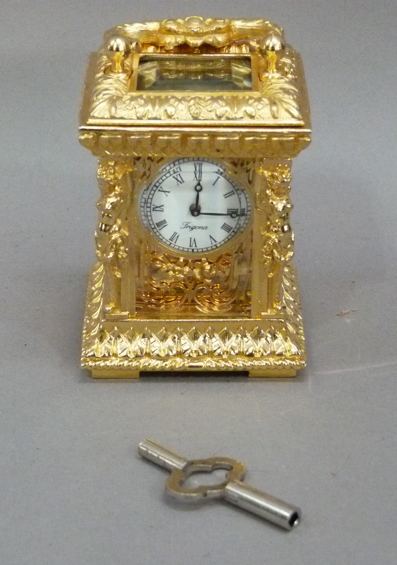 A reproduction gilt metal carriage clock in ornate Rococo case with foliate scroll carrying - Image 3 of 3