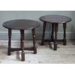 A pair of reproduction oak occasional tables, the circular tops above turned legs and X stretcher,