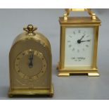 An Acctim quartz mantel clock of arched form with engraved swing handle, 13cm high overall; a