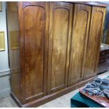 A Victorian mahogany four door wardrobe, the interior fitted with pull slides, short and long